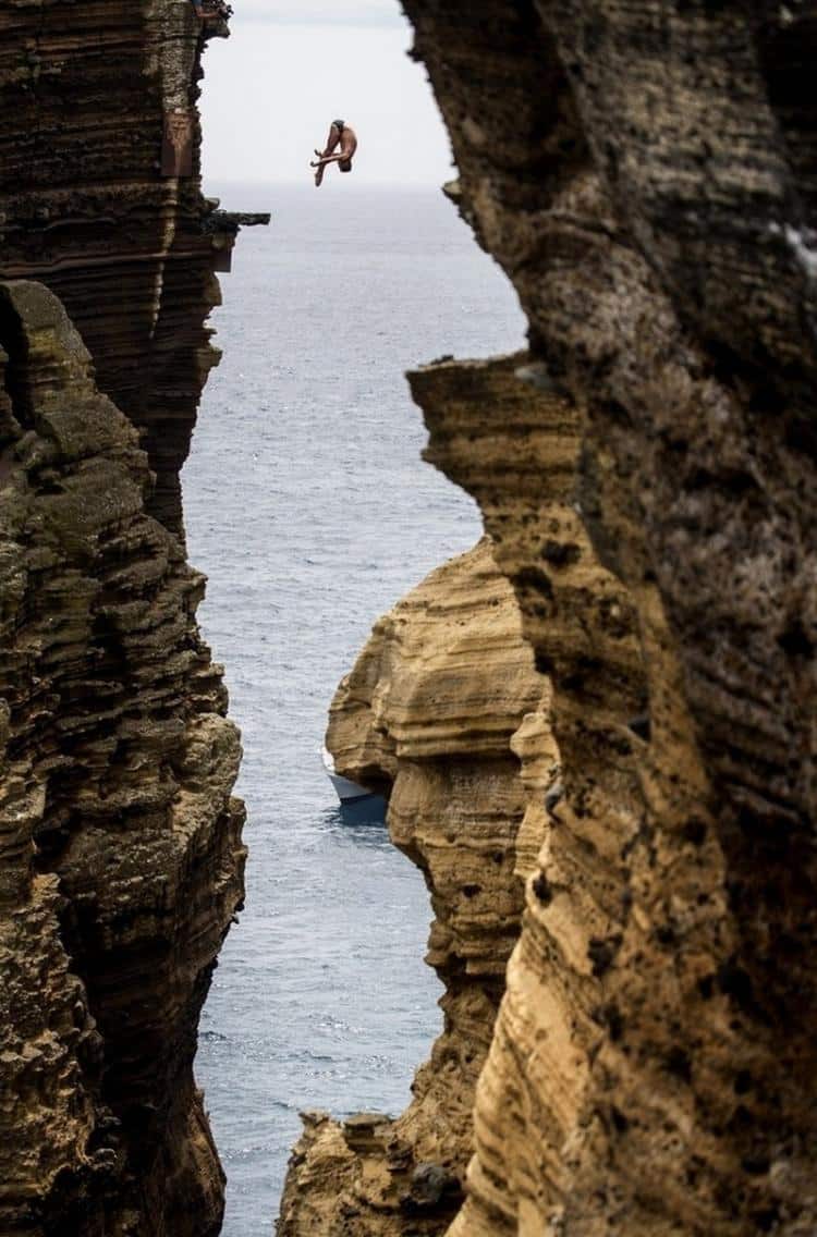 Blake Aldridge dives 29 metres from the rock monolith during the Red Bull Cliff Diving World Series in Portugal High Place